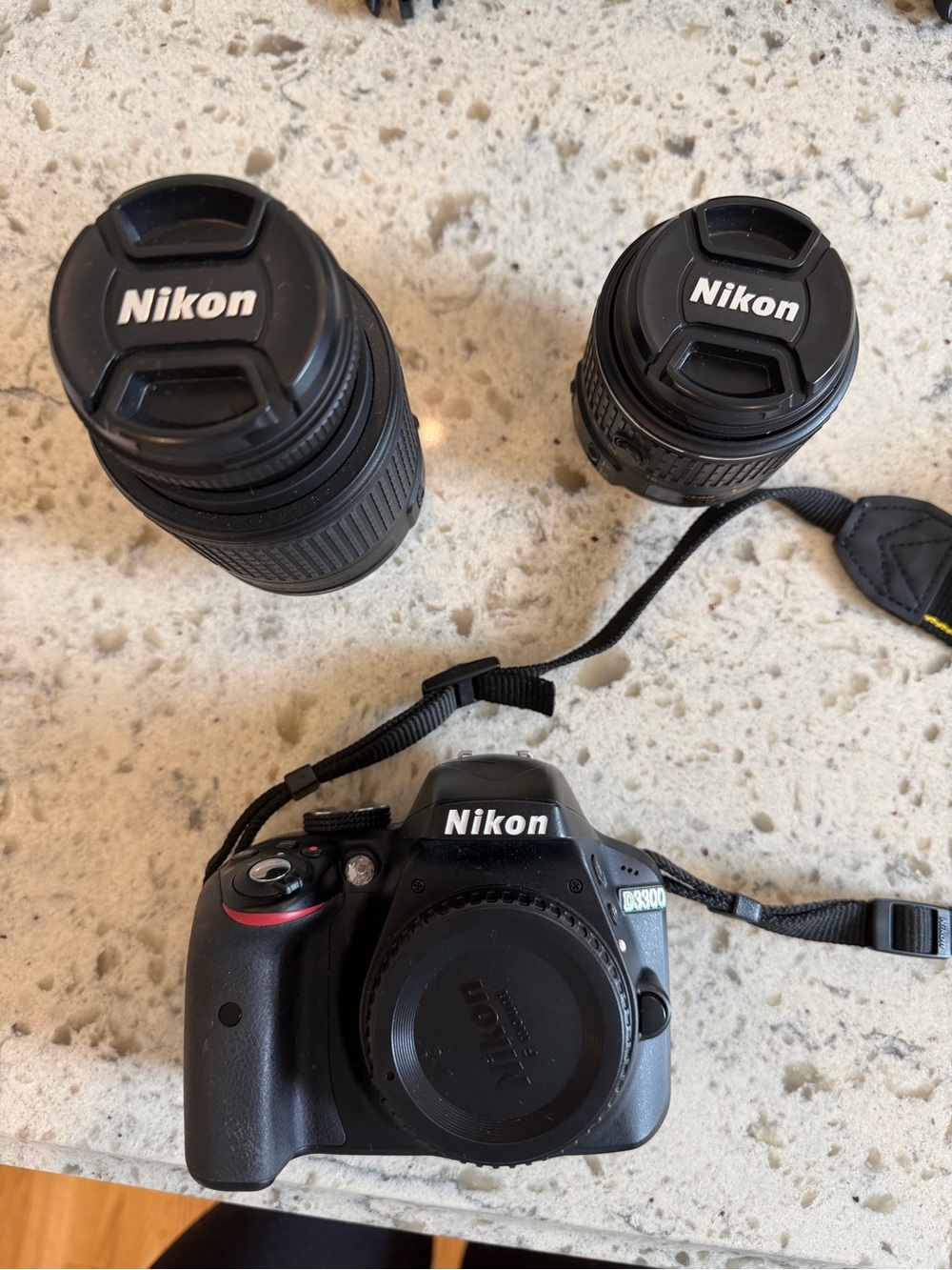 Nikon DSLR Camera Body with Two Black Nikon Lenses and Camera Bags